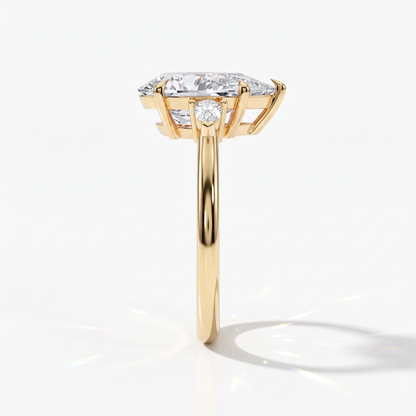 Pear cut lab-grown diamond three-stone engagement ring with pear side stones in 14K (585) yellow gold, side view 