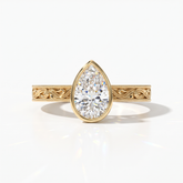 Pear cut lab-grown diamond vintage bezel engagement ring with hand-engraved milgrain band in 14K (585) yellow gold, front view 