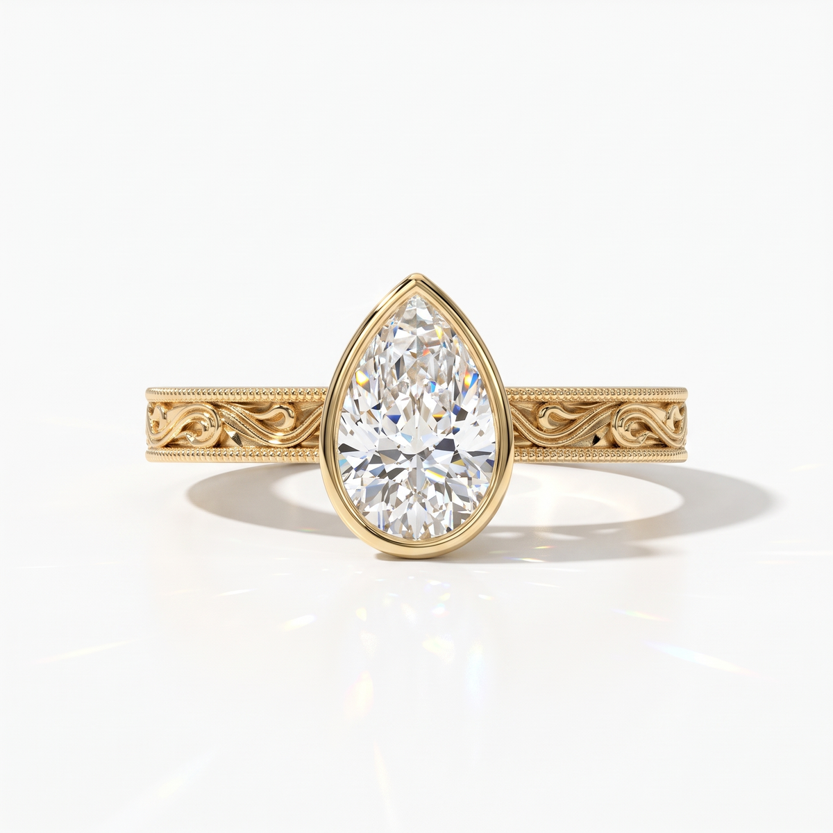 Pear cut lab-grown diamond vintage bezel engagement ring with hand-engraved milgrain band in 14K (585) yellow gold, front view 