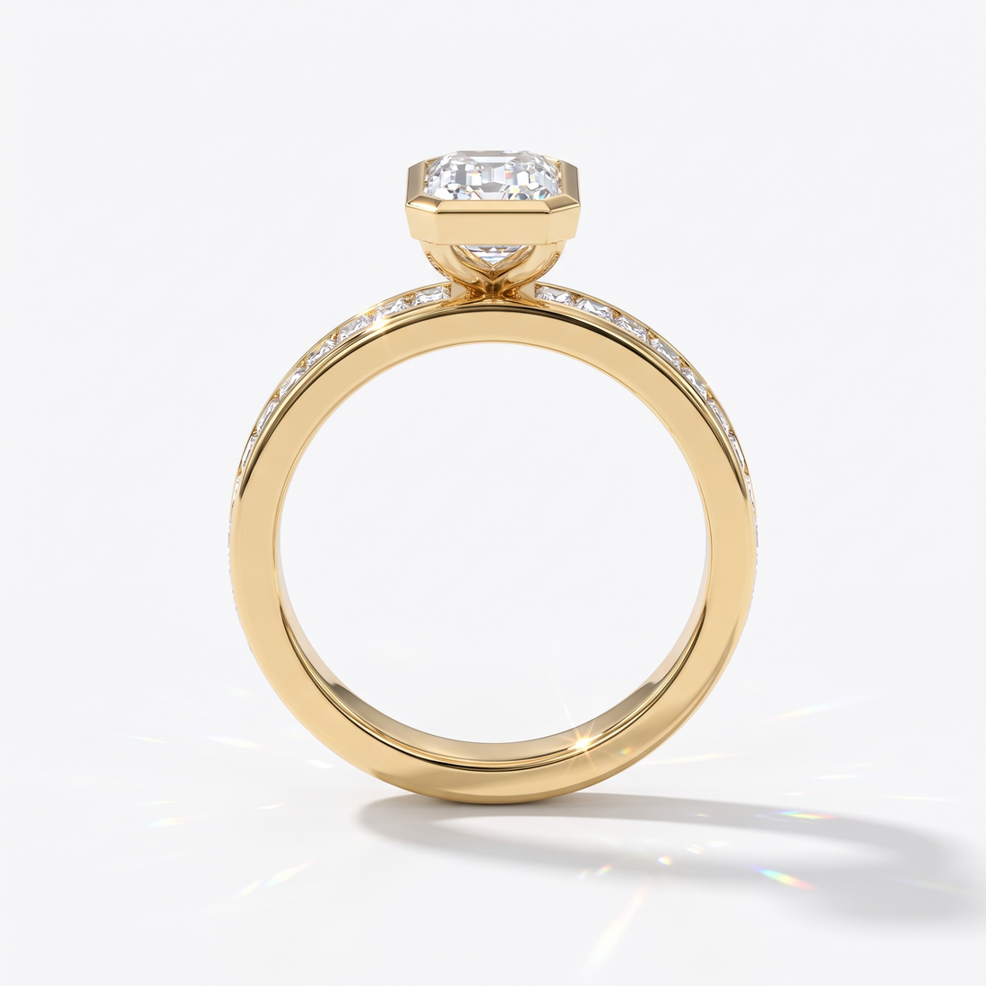 Emerald cut lab-grown diamond bezel engagement ring with channel-set baguette diamonds in 14K (585) yellow gold, upright profile view 