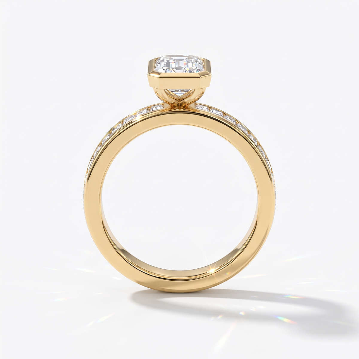 Emerald cut lab-grown diamond bezel engagement ring with channel-set baguette diamonds in 14K (585) yellow gold, upright profile view 