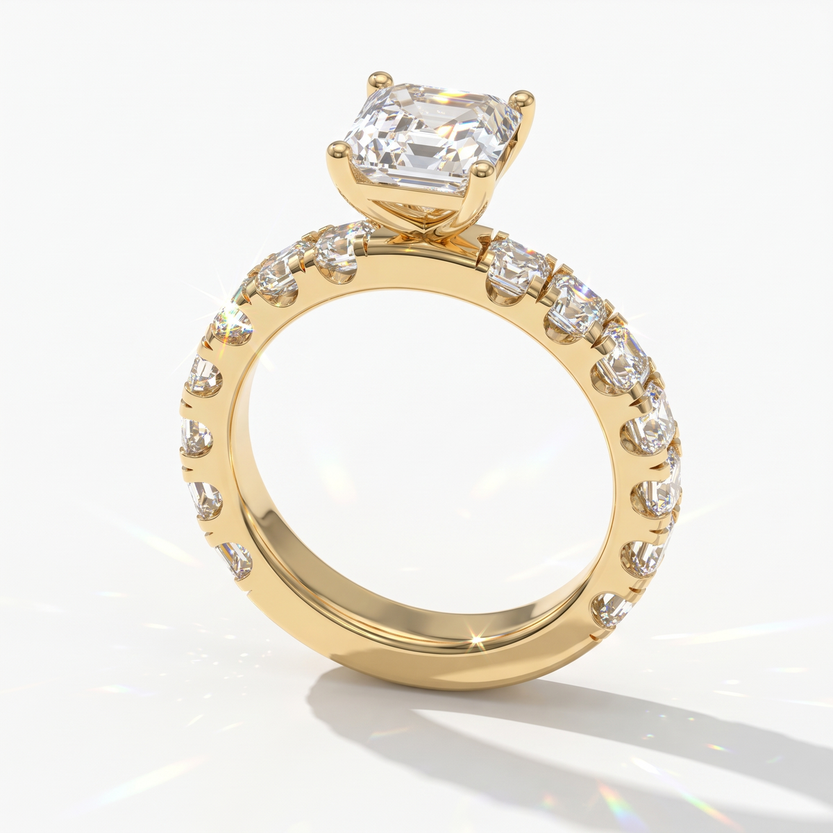 Asscher cut lab-grown diamond engagement ring with Asscher side stones in 14K (585) yellow gold, angled view 