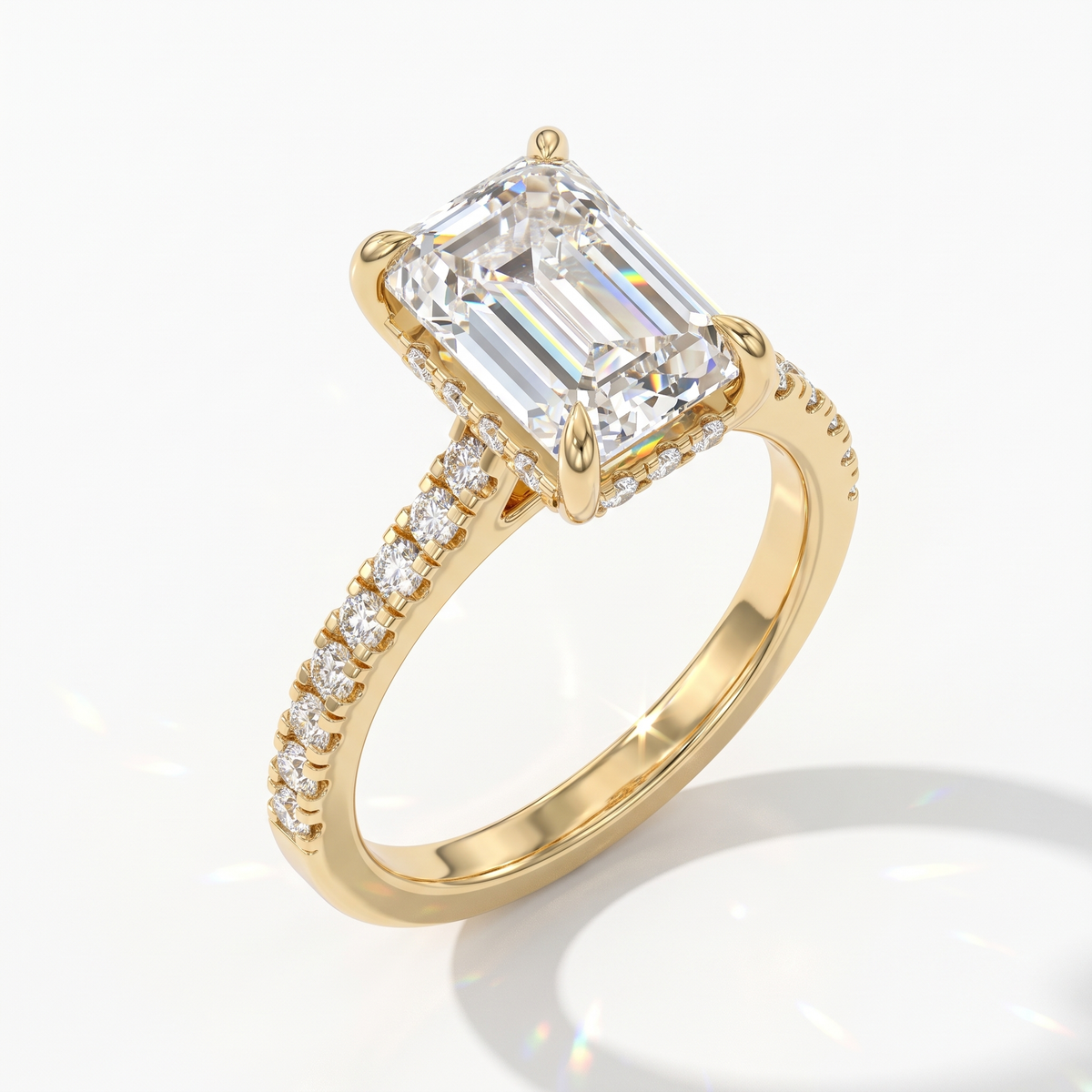 Emerald cut lab-grown diamond hidden halo engagement ring with pavé band in 14K (585) yellow gold, angled view 