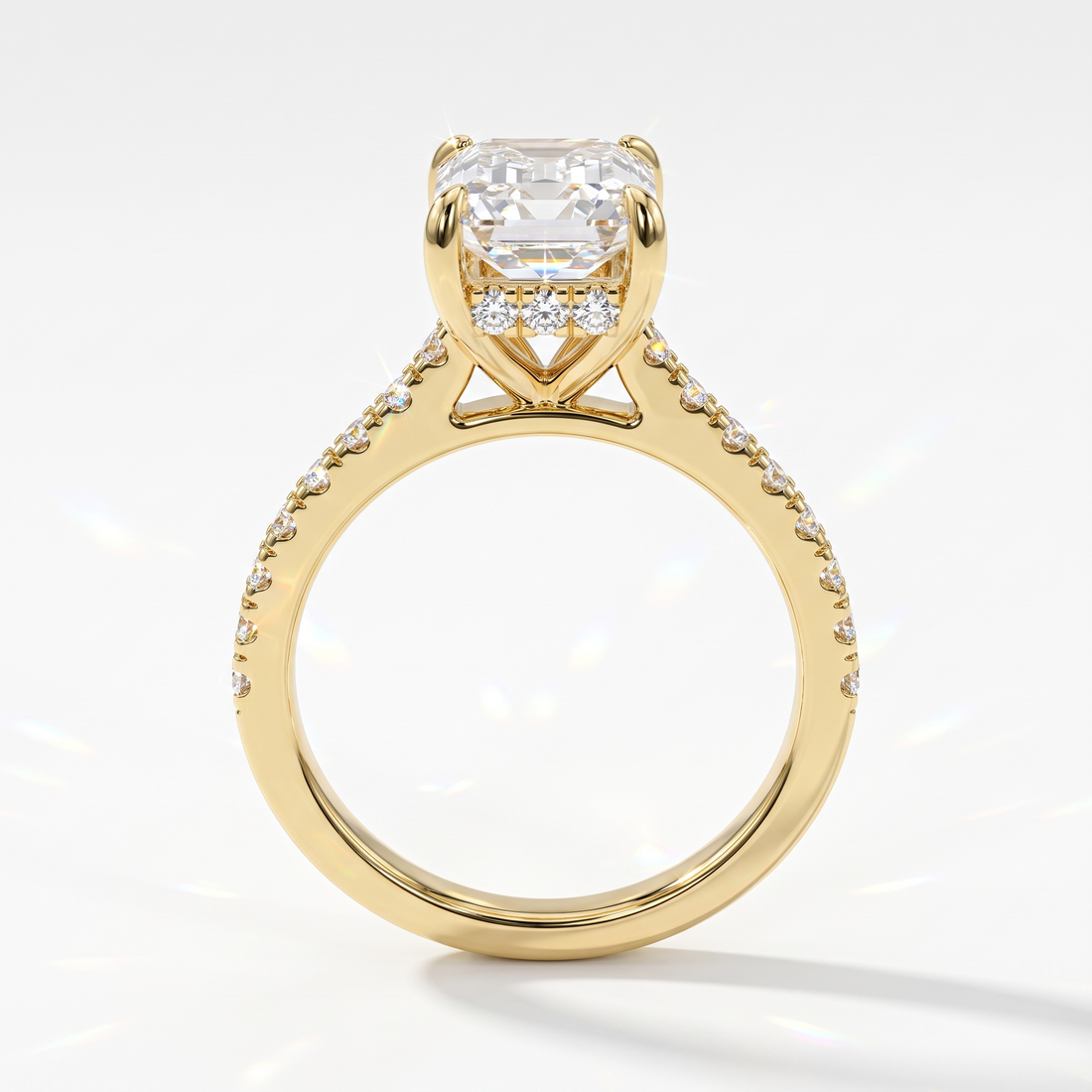 Emerald cut lab-grown diamond hidden halo engagement ring with pavé band in 14K (585) yellow gold, upright profile view 