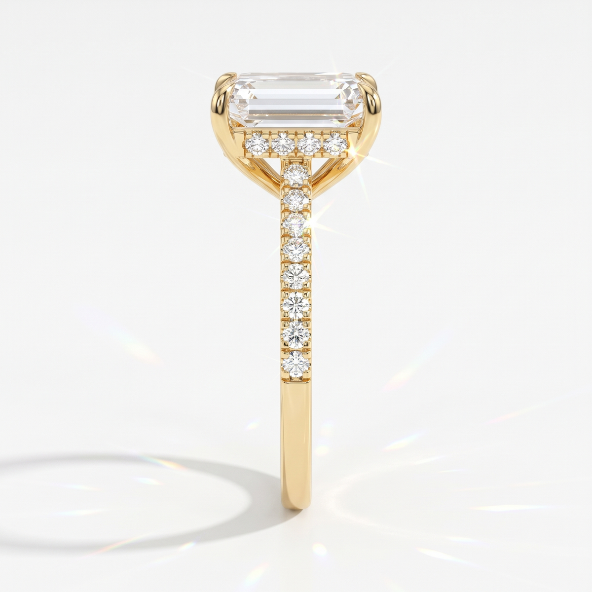 Emerald cut lab-grown diamond hidden halo engagement ring with pavé band in 14K (585) yellow gold, side view 