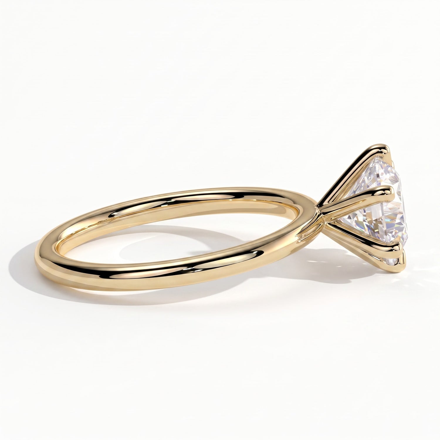 A rose gold engagement ring featuring a large round brilliant-cut diamond, shown in a three-quarter side view on a clean white background. 