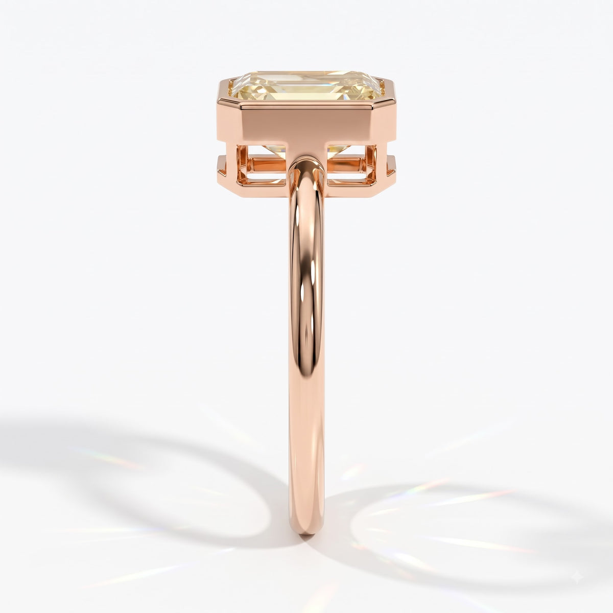 Fancy Intense Yellow emerald cut lab-grown diamond bezel ring in 14K (585) rose gold, side profile 