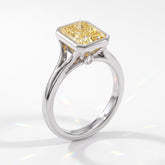 Fancy Vivid Yellow radiant lab-grown diamond bezel ring in 950 platinum, angled view 