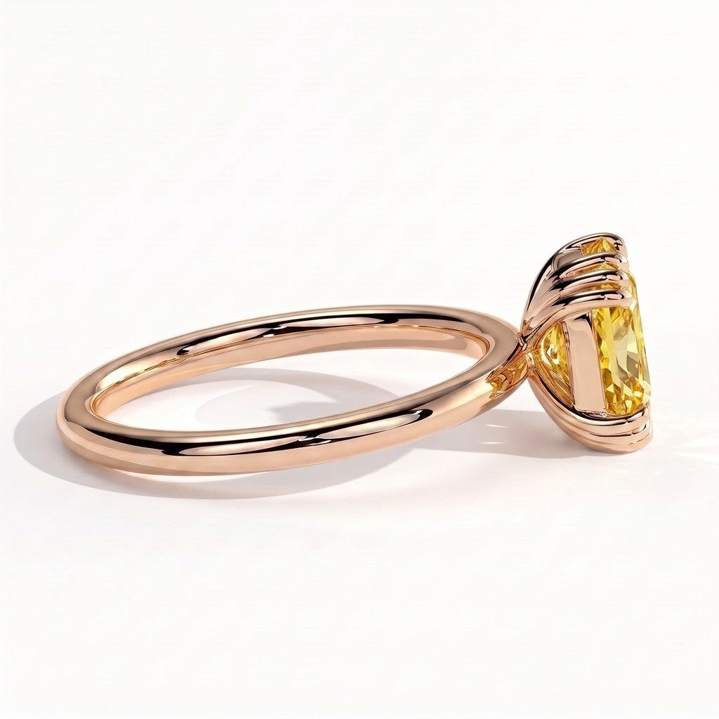 Fancy Vivid Yellow elongated cushion lab-grown diamond solitaire engagement ring with triple claw prongs in 14K (585) rose gold, on white background 