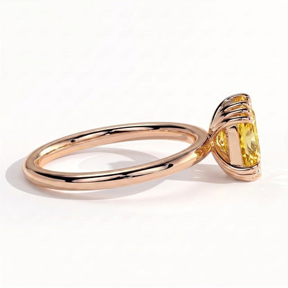 Fancy Vivid Yellow elongated cushion lab-grown diamond solitaire engagement ring with triple claw prongs in 14K (585) rose gold, on white background 