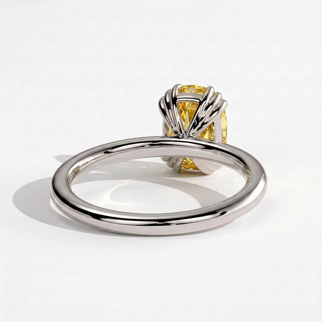 Fancy Vivid Yellow elongated cushion lab-grown diamond solitaire engagement ring with triple claw prongs in 18K (750) white gold, detail view of the triple claws 
