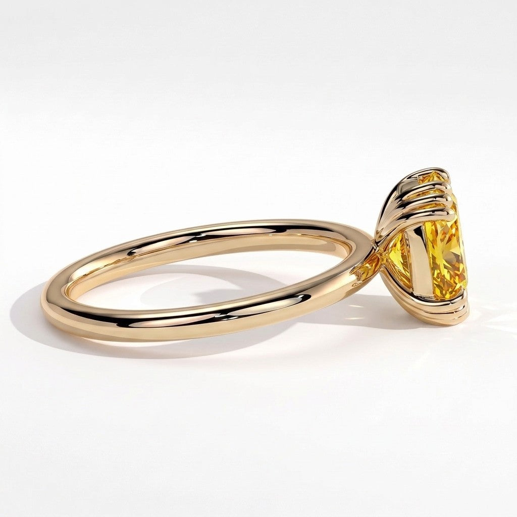 Fancy Vivid Yellow elongated cushion lab-grown diamond solitaire engagement ring with triple claw prongs in 18K (750) yellow gold, detail view of the triple claws 