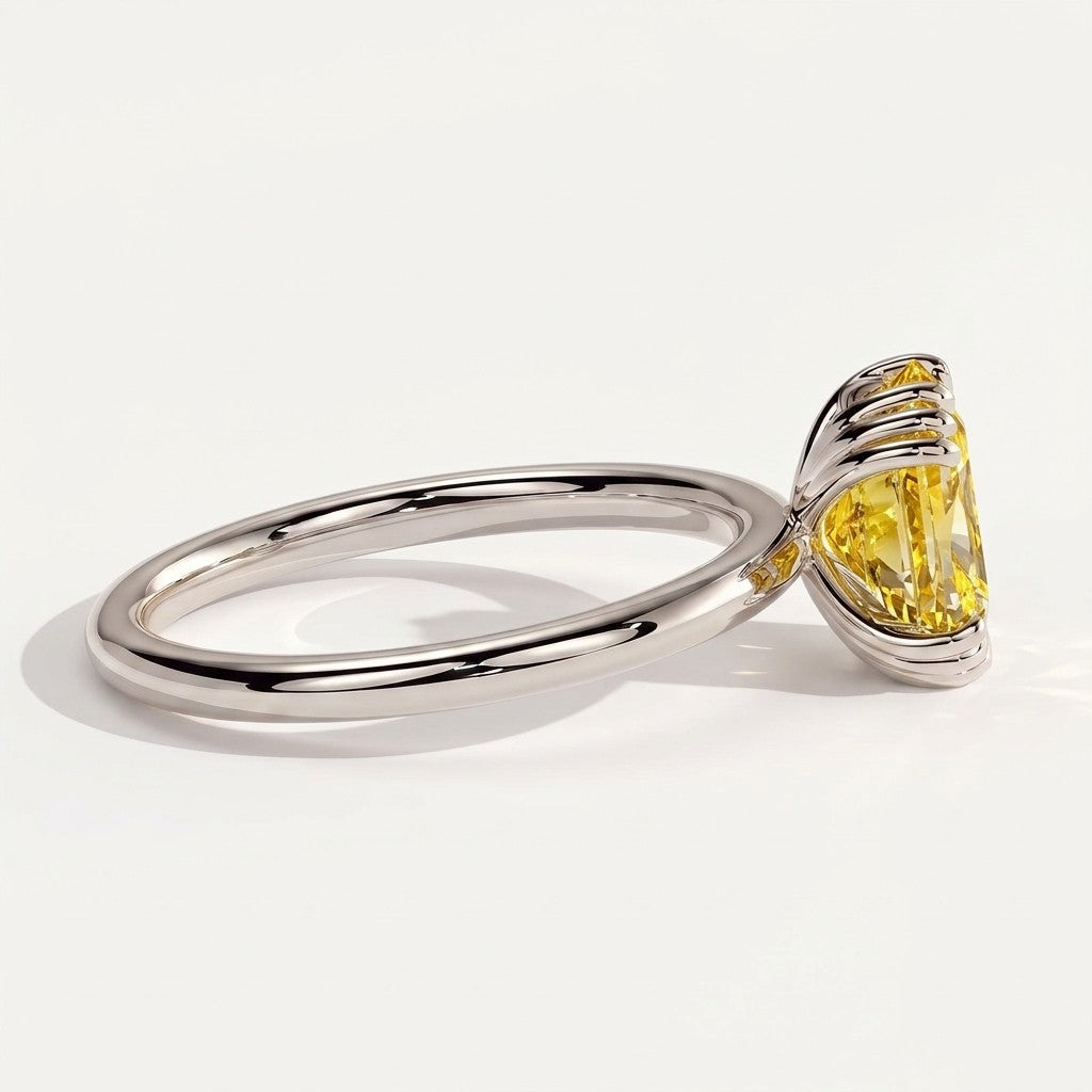 Fancy Vivid Yellow elongated cushion lab-grown diamond solitaire engagement ring with triple claw prongs in 950 platinum, on white background 
