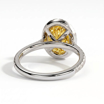 Fancy Vivid Yellow oval lab-grown diamond halo engagement ring with cathedral pavé band in 14K (585) white gold, on white background 