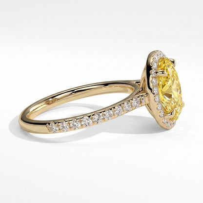 Fancy Vivid Yellow oval lab-grown diamond halo engagement ring with cathedral pavé band in 14K (585) yellow gold, detail view of the halo and pavé band 