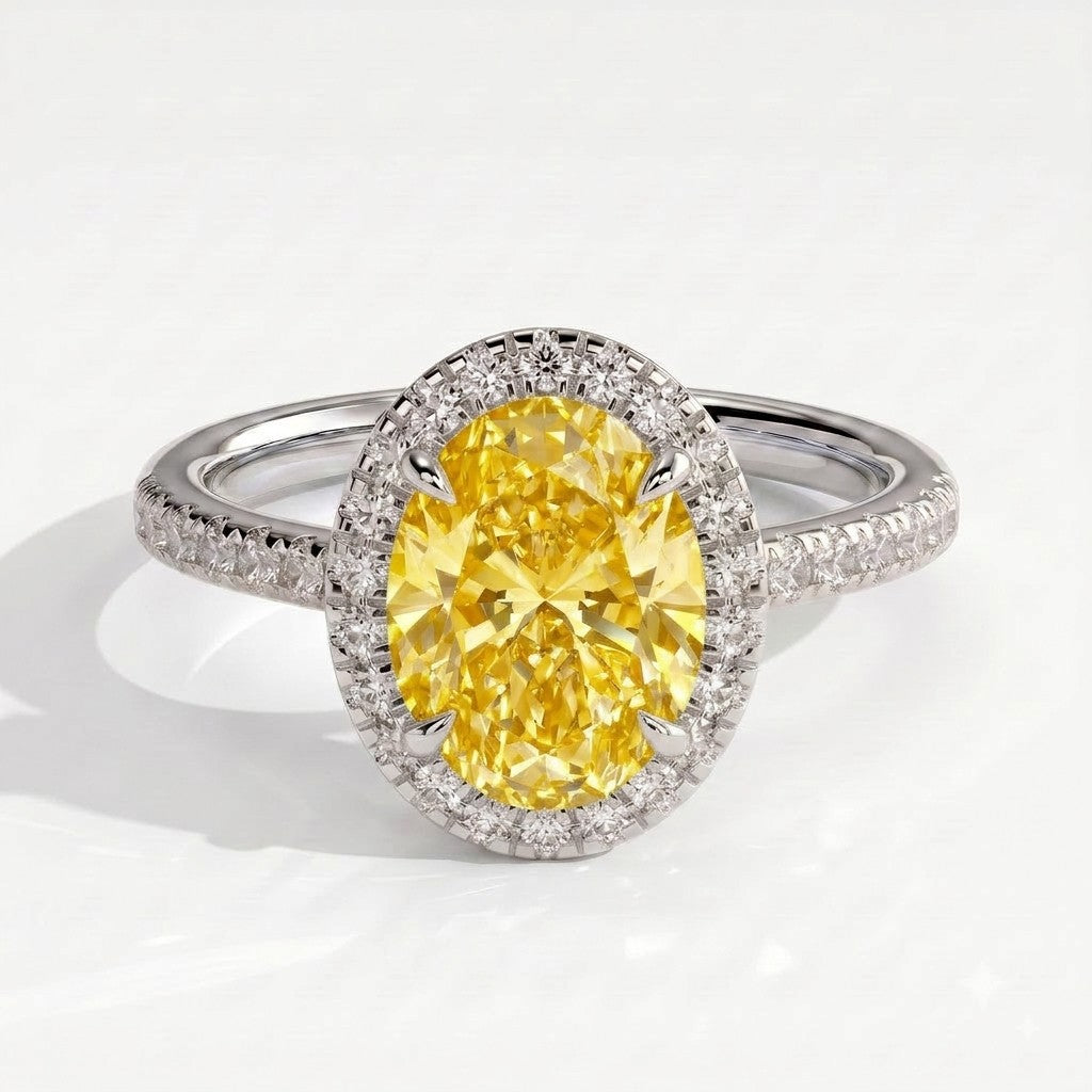 Fancy Vivid Yellow oval lab-grown diamond halo engagement ring with cathedral pavé band in 18K (750) white gold, front view 