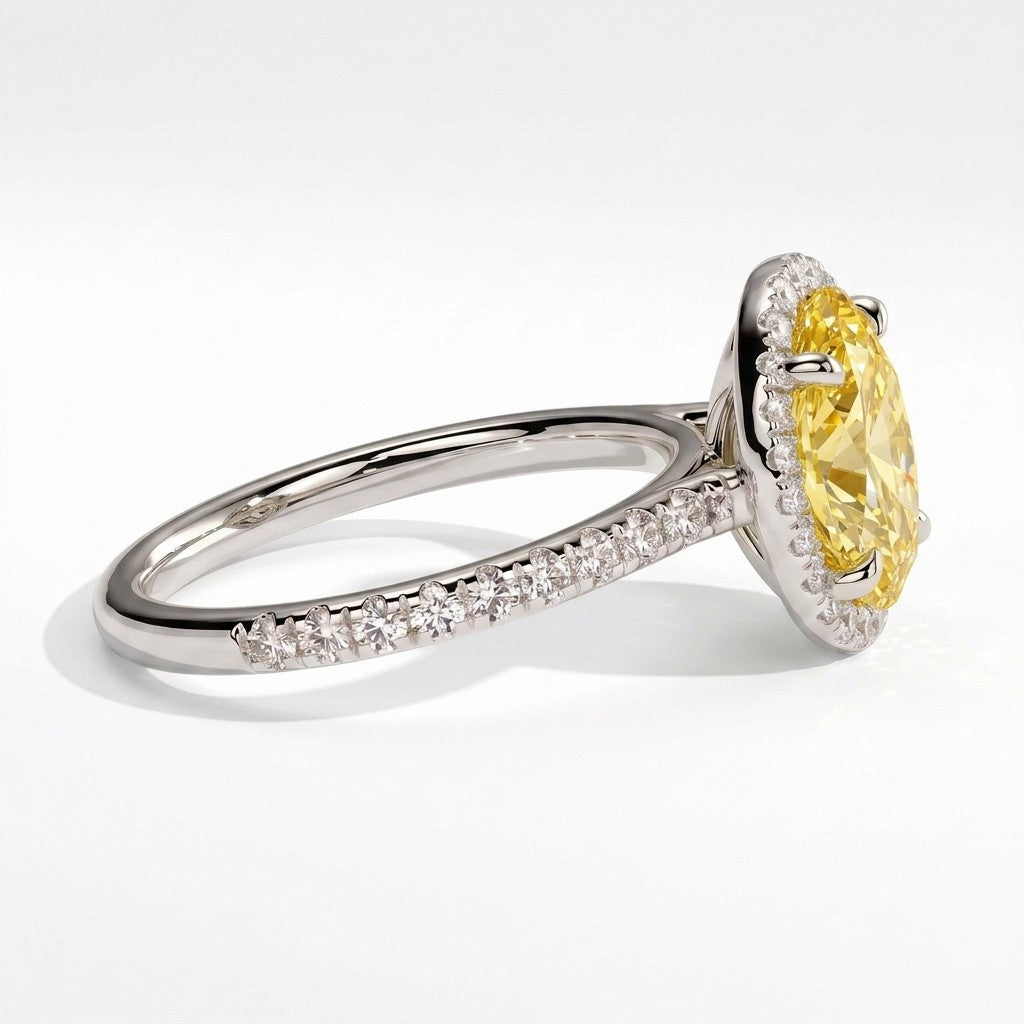 Fancy Vivid Yellow oval lab-grown diamond halo engagement ring with cathedral pavé band in 950 platinum, detail view of the halo and pavé band 
