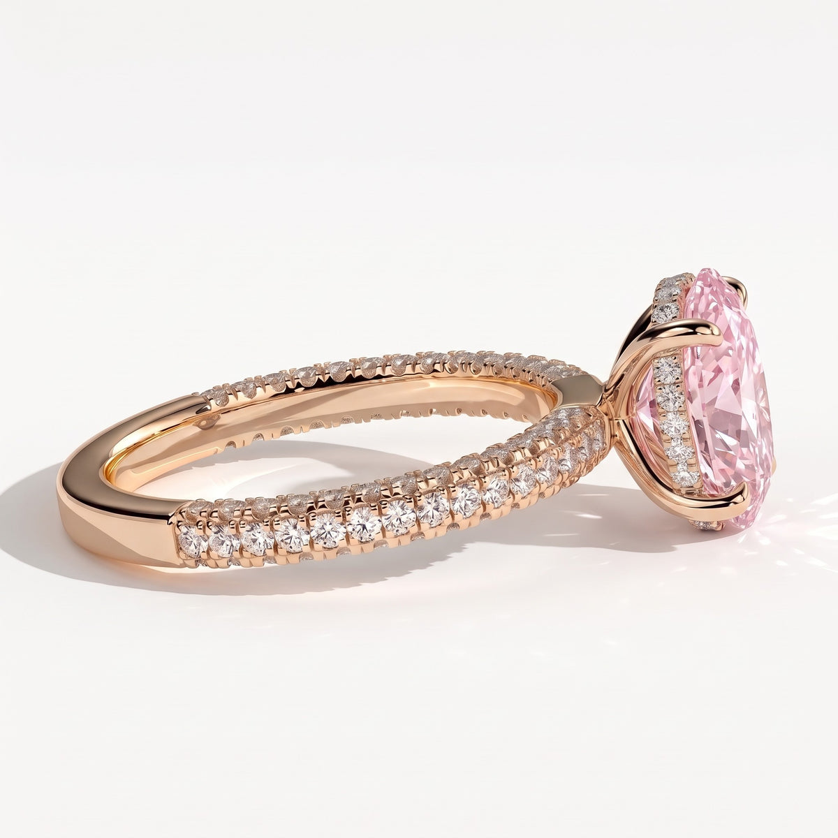 Fancy Vivid Pink oval lab-grown diamond engagement ring with triple pavé band and hidden halo in 14K (585) rose gold, detail view of the triple pavé band 