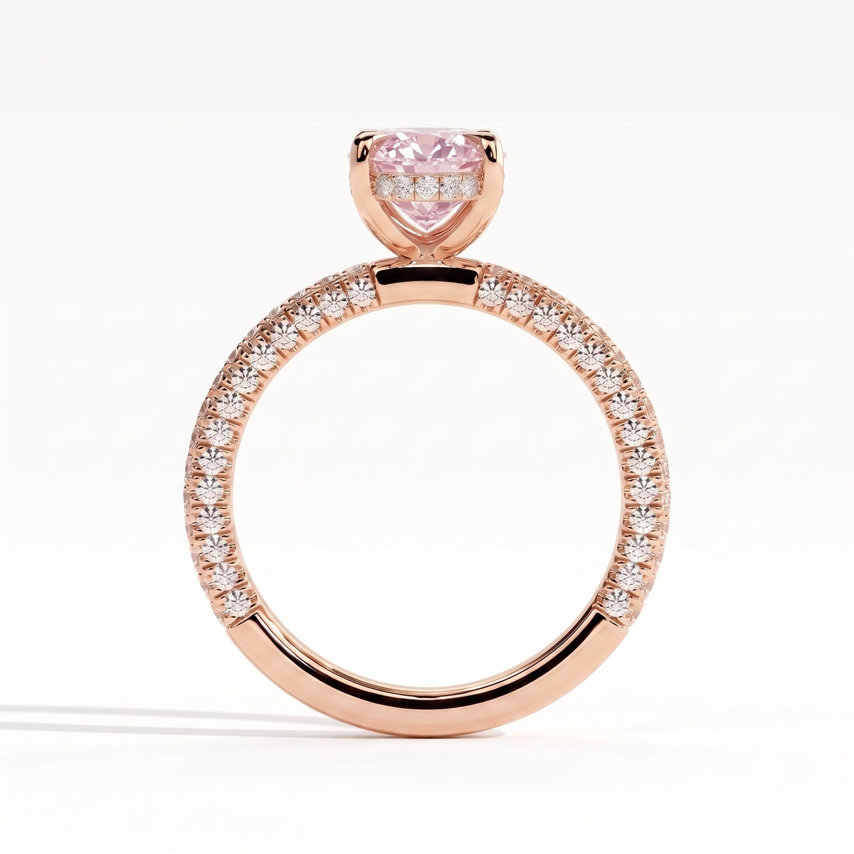 Fancy Vivid Pink oval lab-grown diamond engagement ring with triple pavé band and hidden halo in 14K (585) rose gold, side profile showing the hidden halo 