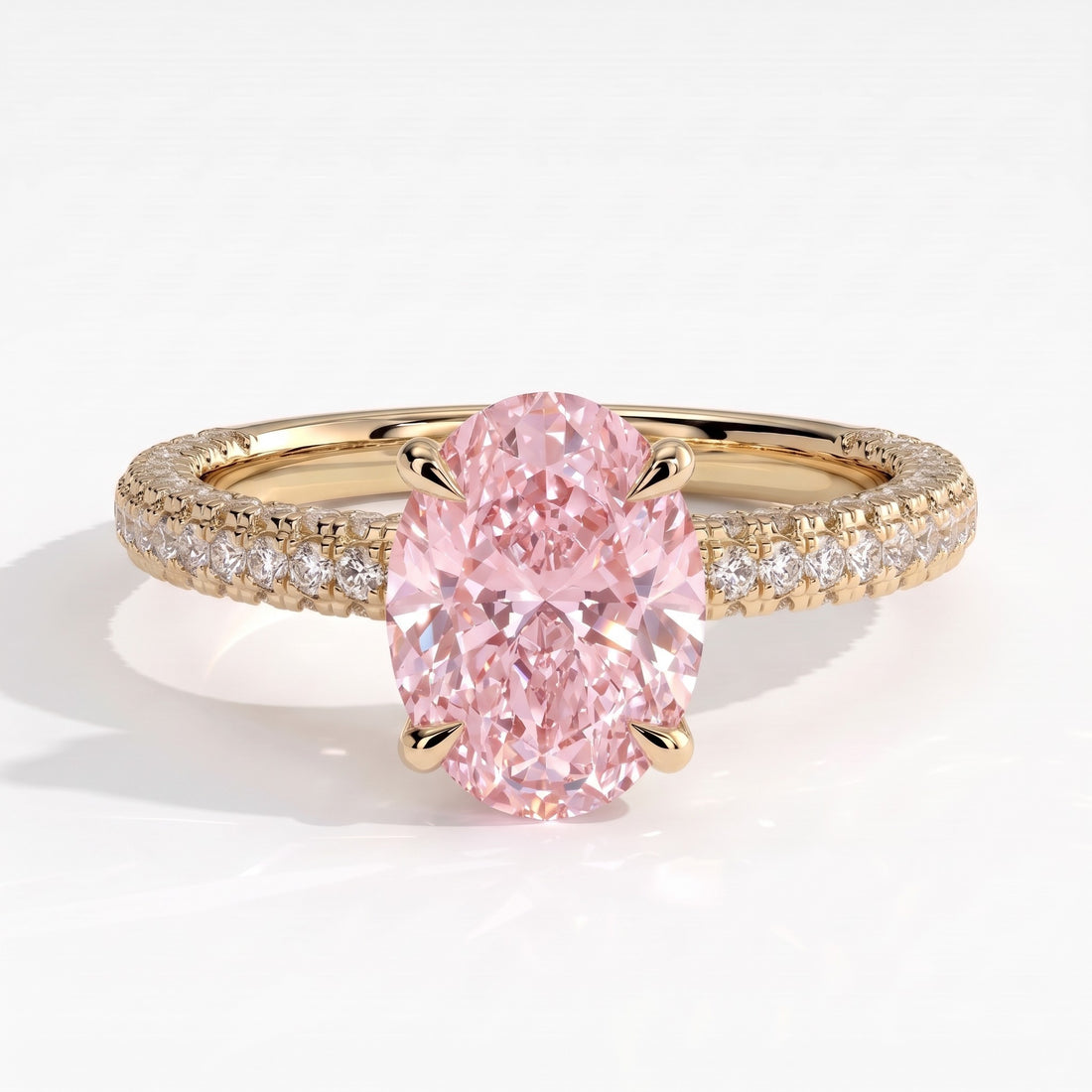 Fancy Vivid Pink oval lab-grown diamond engagement ring with triple pavé band and hidden halo in 14K (585) yellow gold, front view 