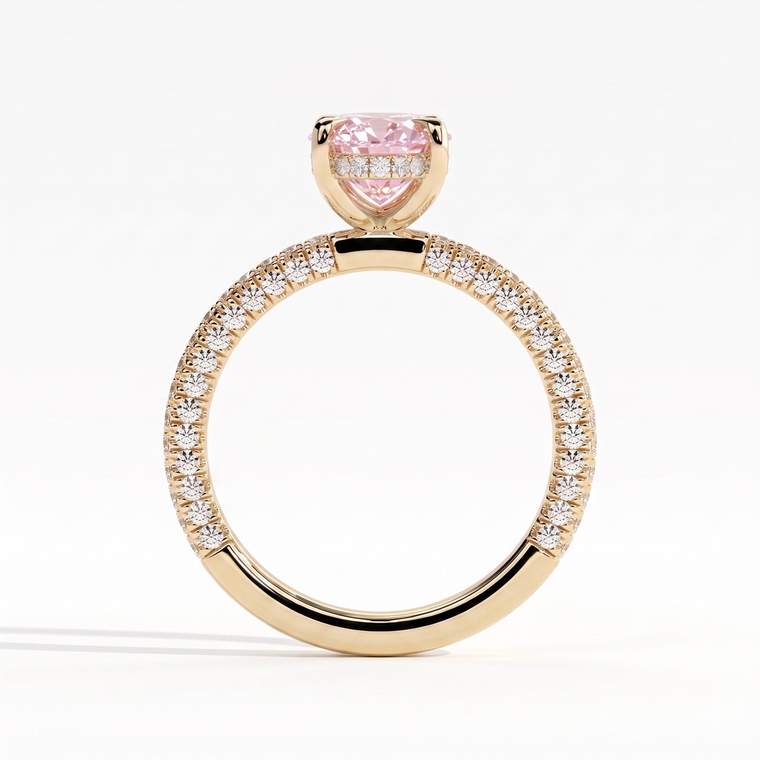 Fancy Vivid Pink oval lab-grown diamond engagement ring with triple pavé band and hidden halo in 14K (585) yellow gold, side profile showing the hidden halo 