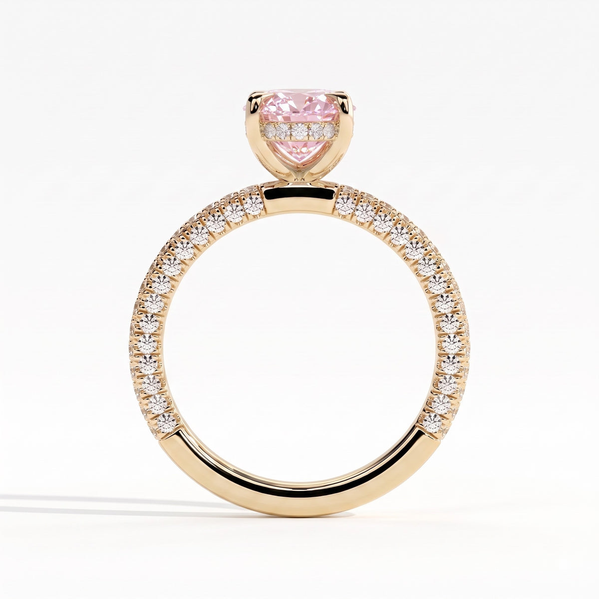 Fancy Vivid Pink oval lab-grown diamond engagement ring with triple pavé band and hidden halo in 14K (585) yellow gold, side profile showing the hidden halo 