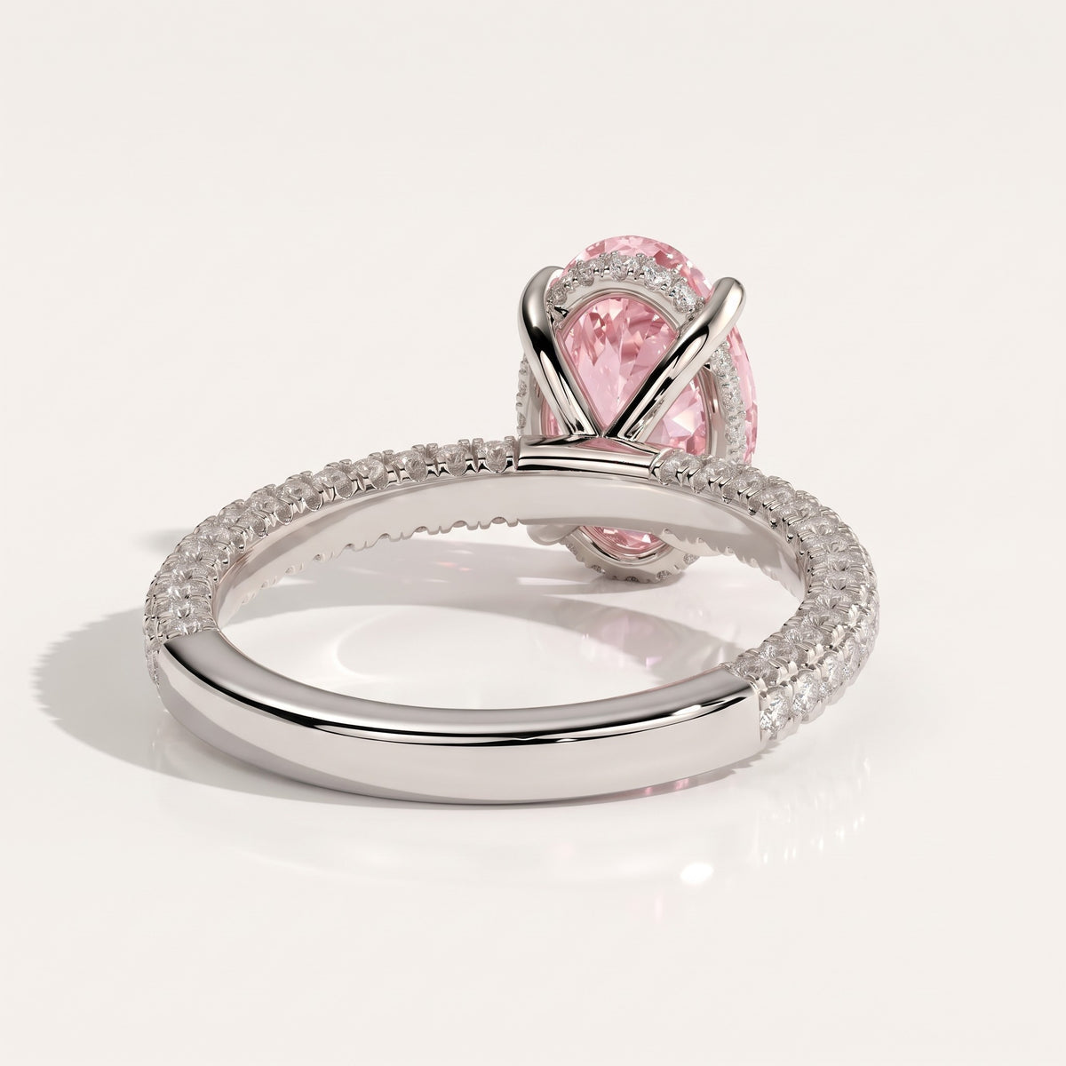 Fancy Vivid Pink oval lab-grown diamond engagement ring with triple pavé band and hidden halo in 950 platinum, back view 