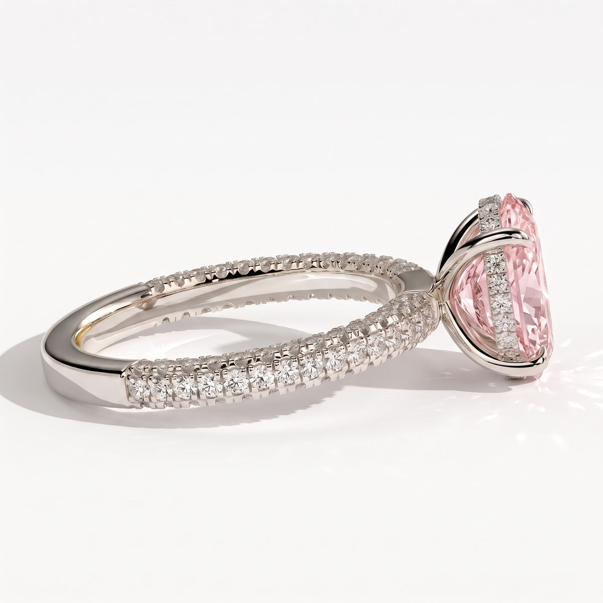 Fancy Vivid Pink oval lab-grown diamond engagement ring with triple pavé band and hidden halo in 950 platinum, detail view of the triple pavé band 