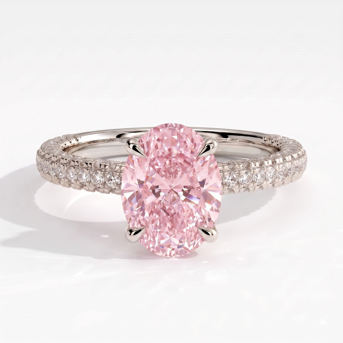 Fancy Vivid Pink oval lab-grown diamond engagement ring with triple pavé band and hidden halo in 950 platinum, front view 