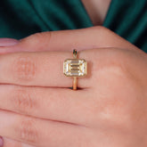 Fancy Intense Yellow emerald cut lab-grown diamond bezel ring in 950 platinum, worn on finger, on-hand top view 