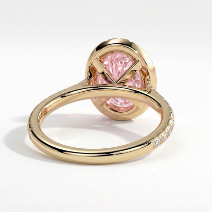 Fancy Vivid Pink oval lab-grown diamond halo engagement ring with cathedral pavé band in 14K (585) yellow gold, on white background 