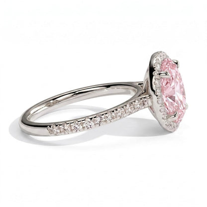Fancy Vivid Pink oval lab-grown diamond halo engagement ring with cathedral pavé band in 18K (750) white gold, detail view of the halo and pavé band 