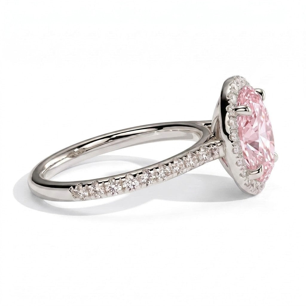 Fancy Vivid Pink oval lab-grown diamond halo engagement ring with cathedral pavé band in 950 platinum, detail view of the halo and pavé band 