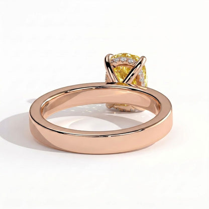 Fancy Vivid Yellow elongated cushion lab-grown diamond engagement ring with flat cigar band and hidden halo in 14K (585) rose gold, on white background 