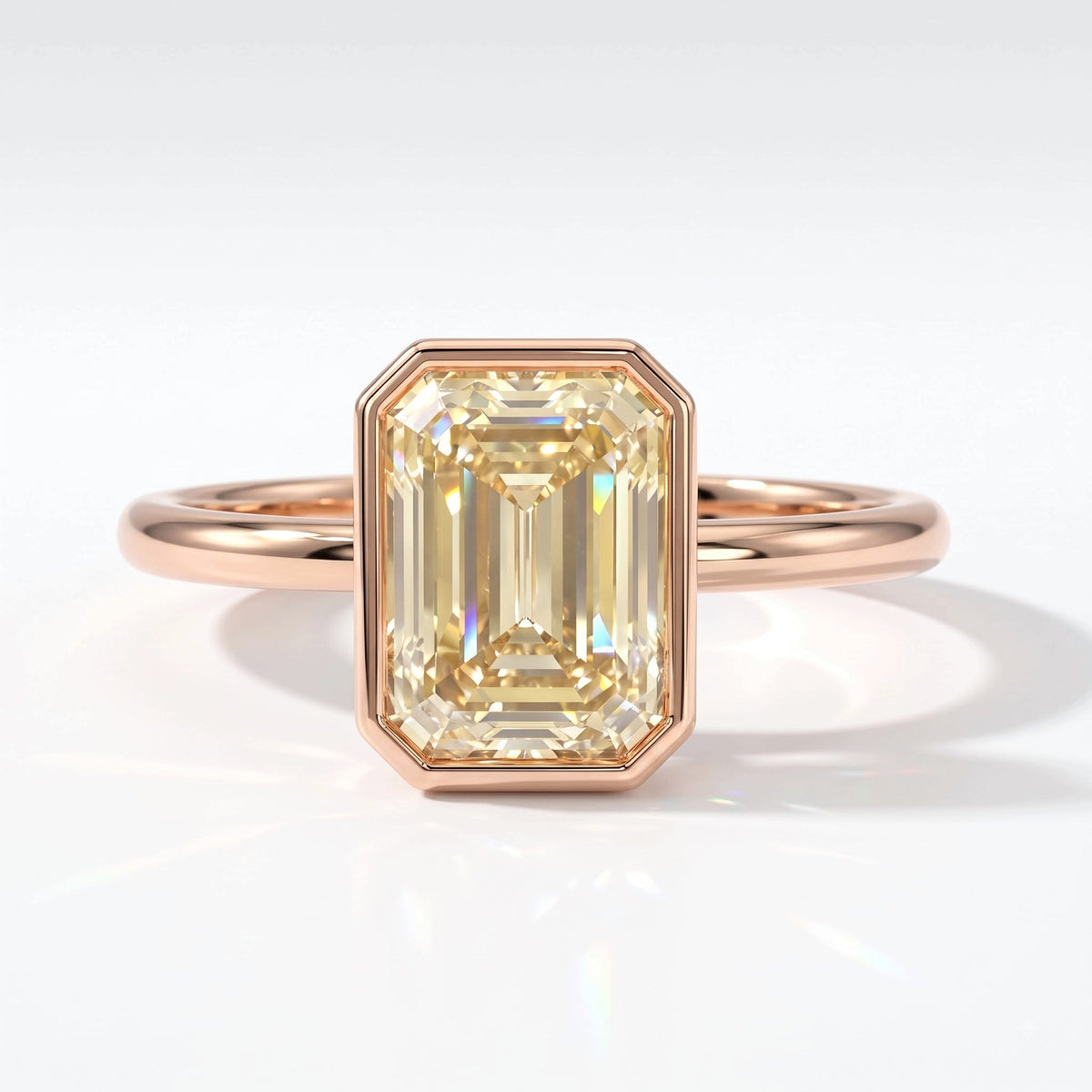 Fancy Intense Yellow emerald cut lab-grown diamond bezel ring in 14K (585) rose gold, top view 