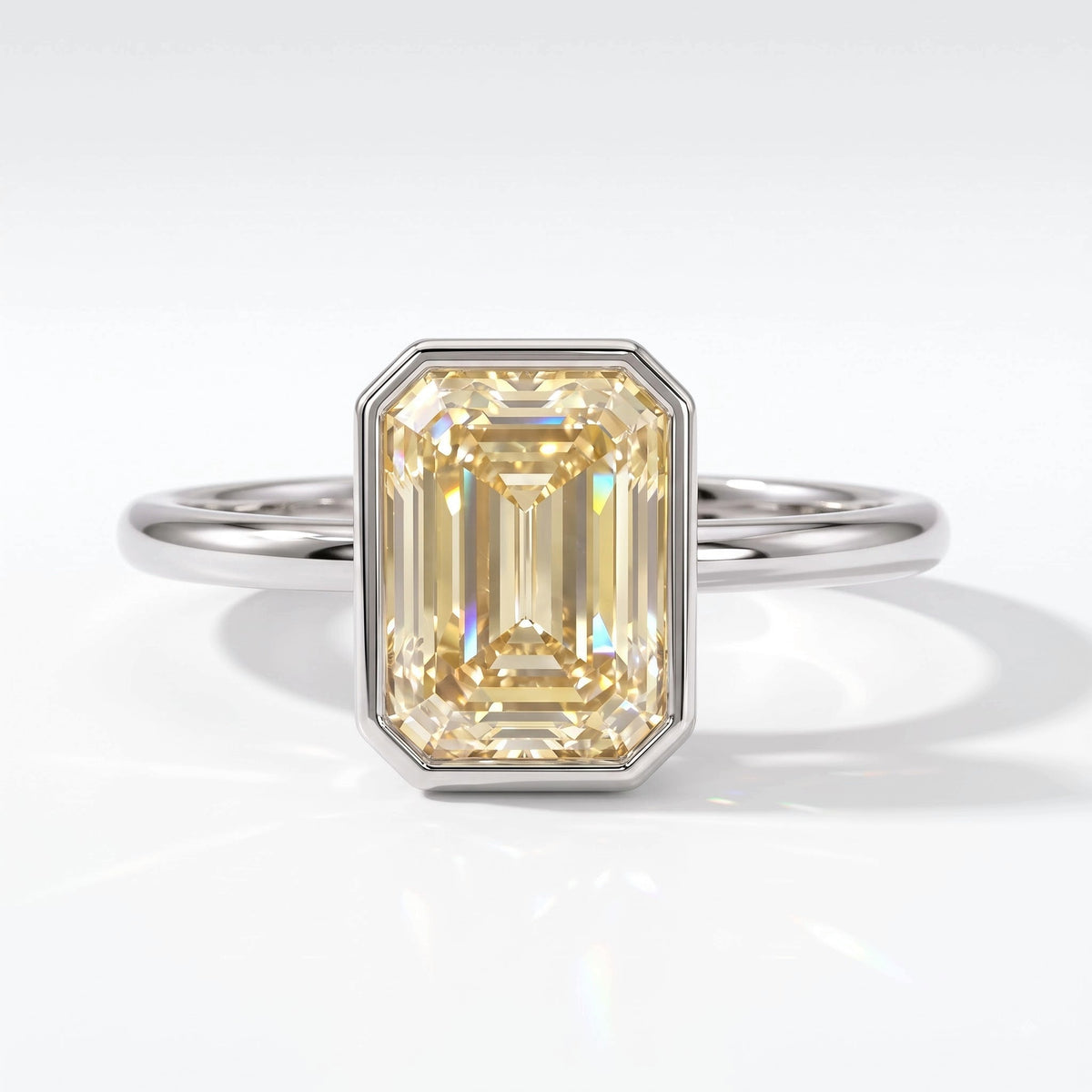 Fancy Intense Yellow emerald cut lab-grown diamond bezel ring in 18K (750) white gold, top view 