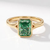 Fancy Vivid Green radiant lab-grown diamond bezel ring in 18K (750) yellow gold, angled top view 