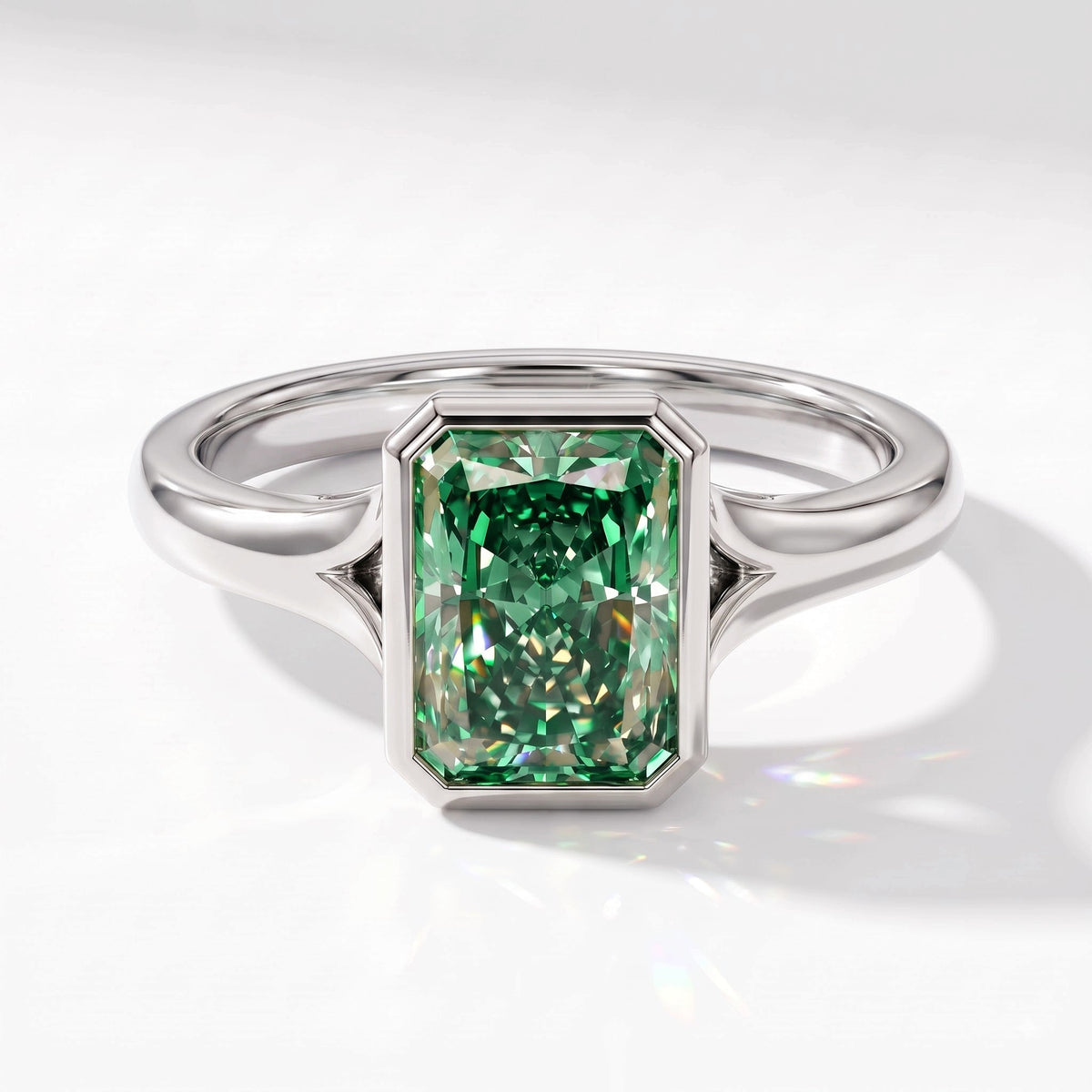Fancy Vivid Green radiant lab-grown diamond bezel ring in 18K (750) white gold, angled top view 