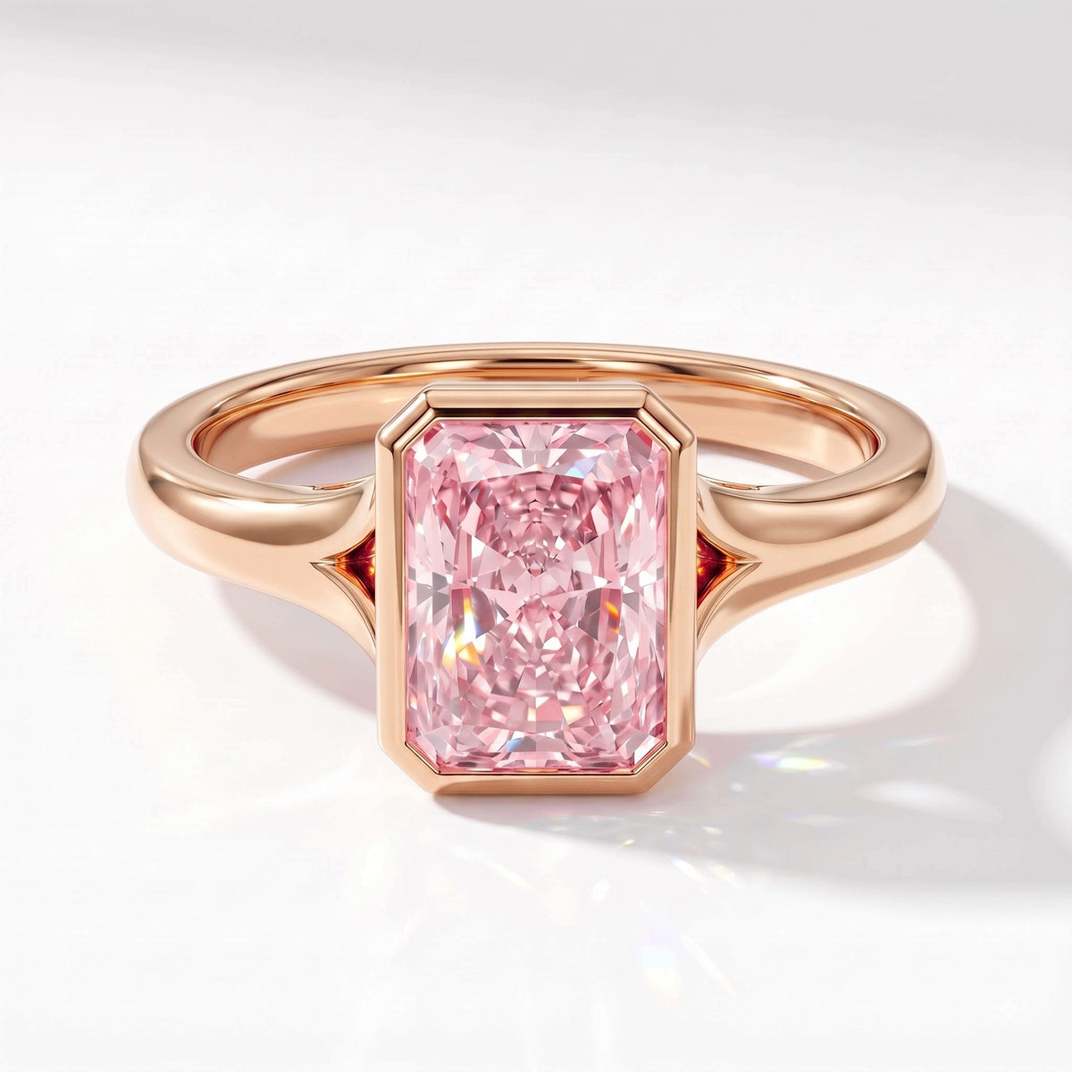Fancy Vivid Pink radiant lab-grown diamond bezel ring in 14K (585) rose gold, angled top view 
