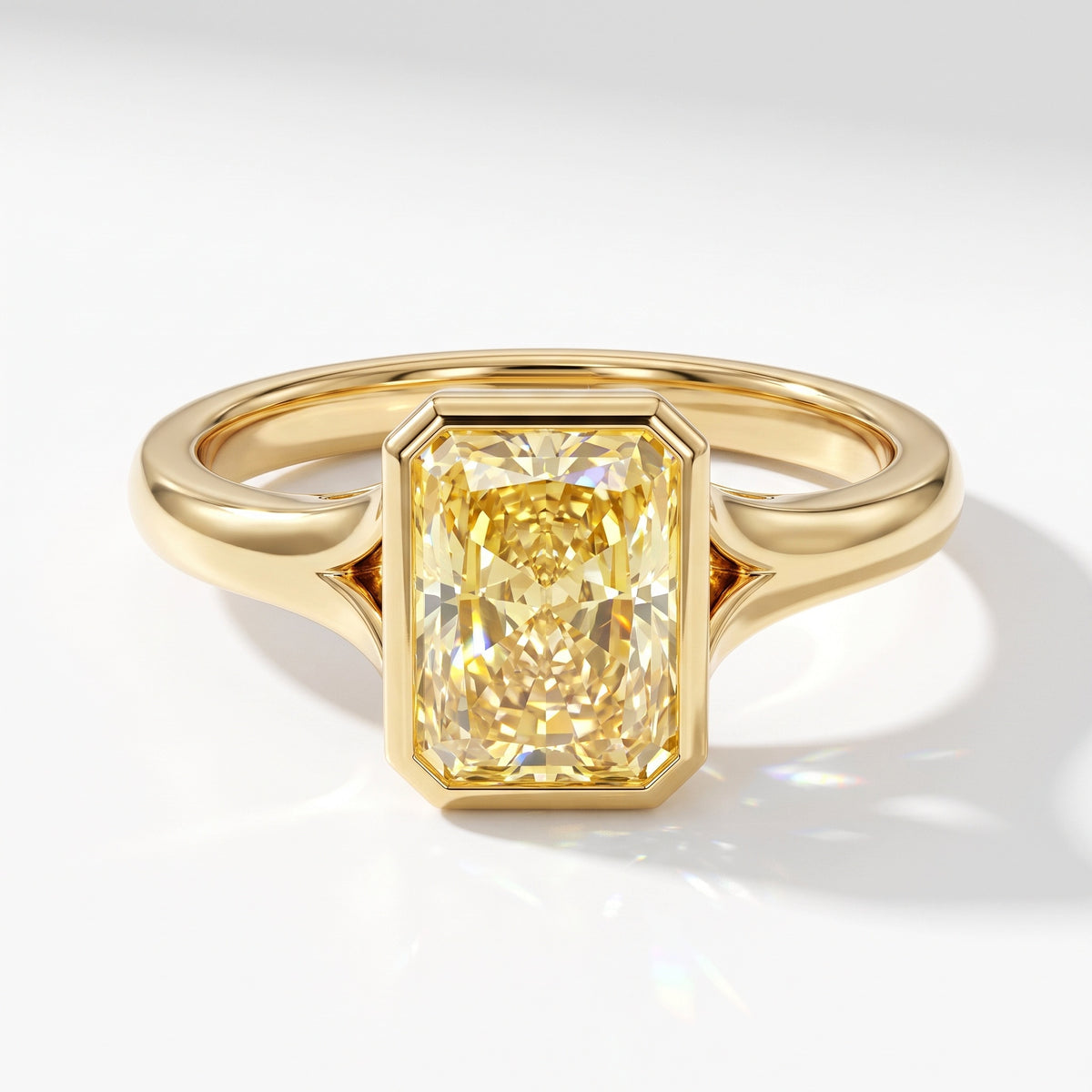 Fancy Vivid Yellow radiant lab-grown diamond bezel ring in 18K (750) yellow gold, angled top view 