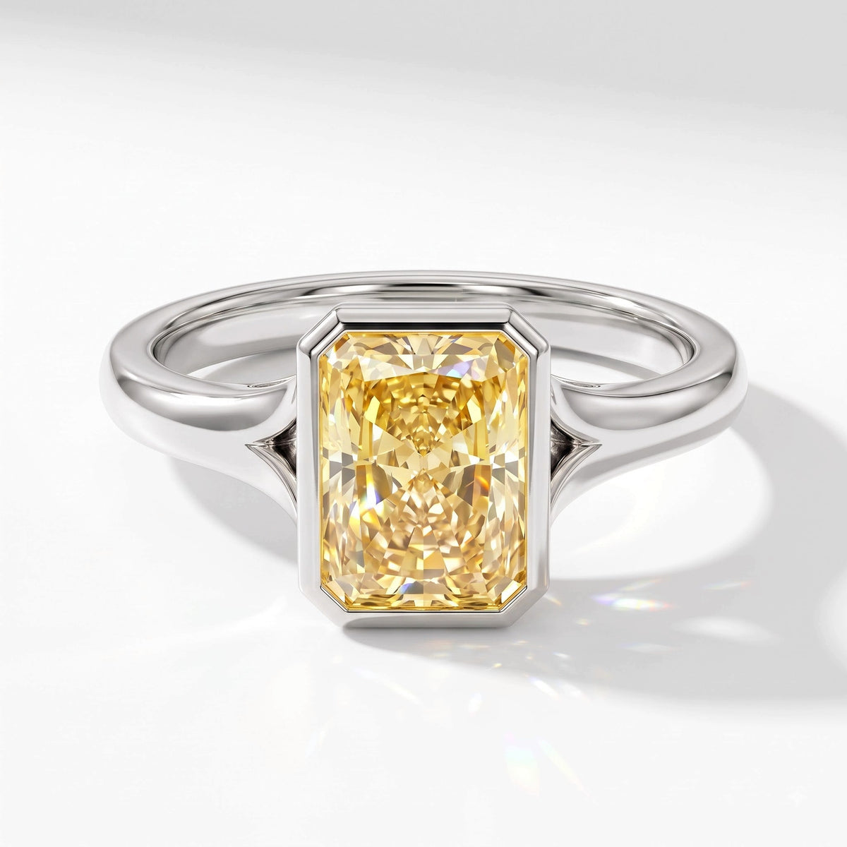 Fancy Vivid Yellow radiant lab-grown diamond bezel ring in 950 platinum, angled top view 