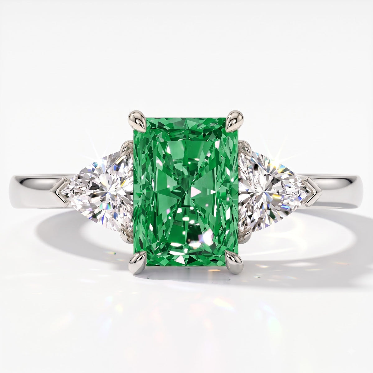 Fancy Vivid Green radiant lab-grown diamond three-stone ring with trillion side diamonds in 18K (750) white gold, top view 
