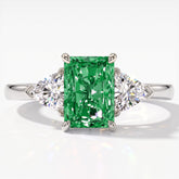 Fancy Vivid Green radiant lab-grown diamond three-stone ring with trillion side diamonds in 950 platinum, top view 