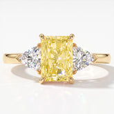 Fancy Vivid Yellow radiant lab-grown diamond three-stone ring with trillion side diamonds in 14K (585) yellow gold, top view 
