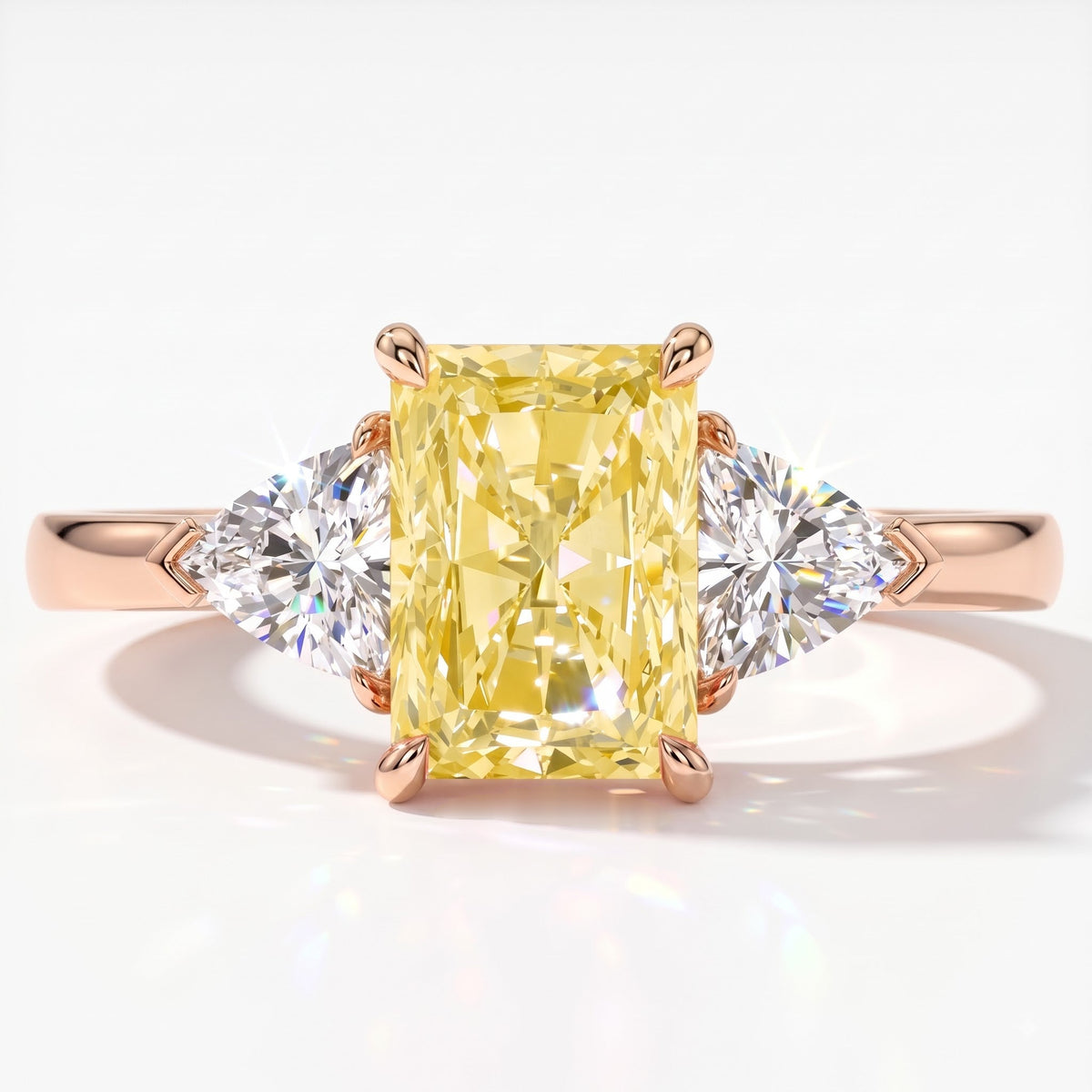 Fancy Vivid Yellow radiant lab-grown diamond three-stone ring with trillion side diamonds in 14K (585) rose gold, top view 