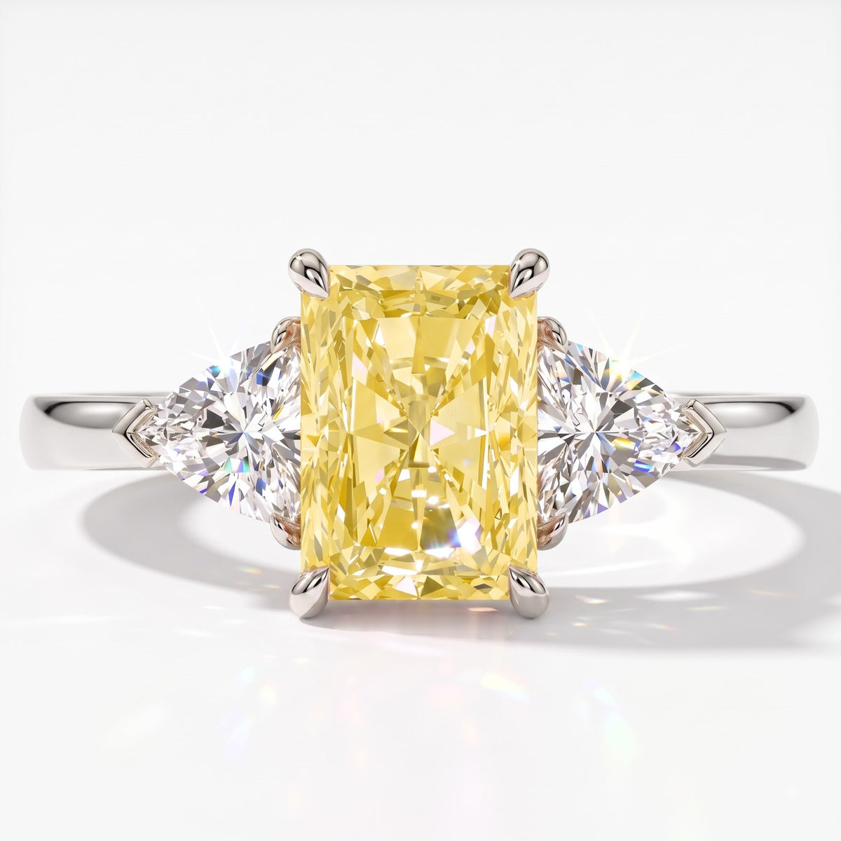 Fancy Vivid Yellow radiant lab-grown diamond three-stone ring with trillion side diamonds in 18K (750) white gold, top view 