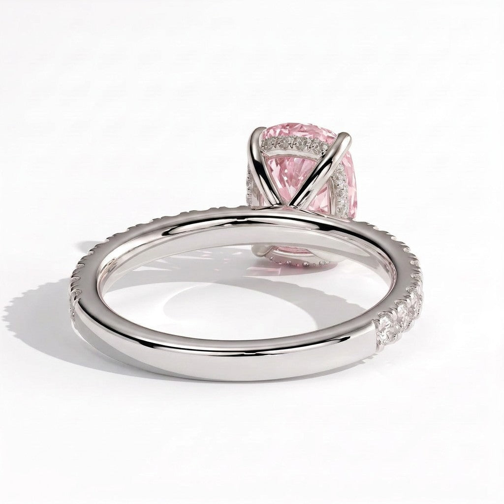 Fancy Vivid Pink elongated cushion lab-grown diamond engagement ring with hidden halo and pavé band in 950 platinum, on white background 