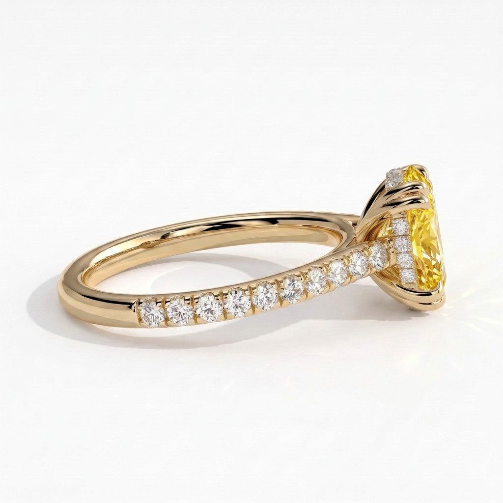Fancy Vivid Yellow oval lab-grown diamond double claw engagement ring with pavé band and hidden halo in 18K (750) yellow gold, detail view of the pavé band 