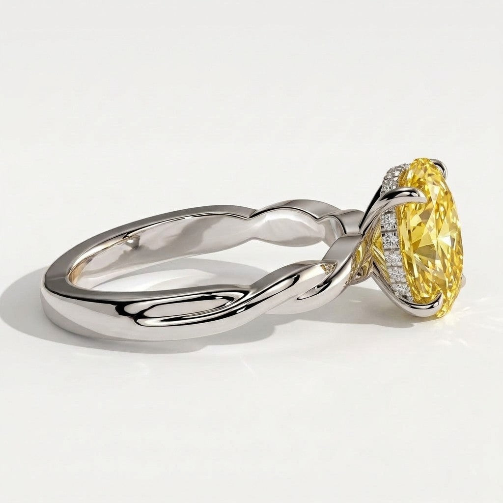 Fancy Vivid Yellow oval lab-grown diamond solitaire engagement ring with twisted band in 18K (750) white gold, detail view of the twisted band 