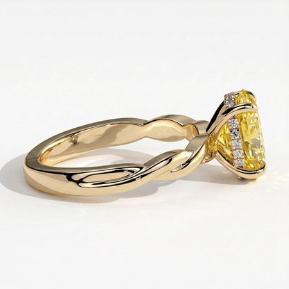 Fancy Vivid Yellow oval lab-grown diamond solitaire engagement ring with twisted band in 18K (750) yellow gold, detail view of the twisted band 